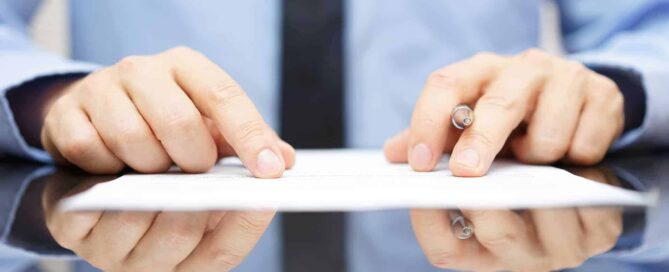 businessman carefully reviewing papers|businessman carefully reviewing papers|businessman carefully reviewing papers