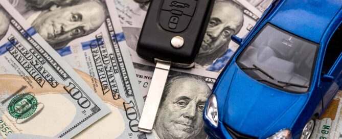 car keys and model car laying on 100 dollar bills|car keys and model car laying on 100 dollar bills|car keys and model car laying on 100 dollar bills